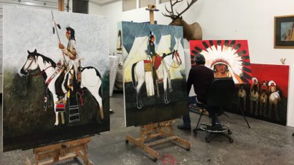 Artist painting Native American-themed artwork