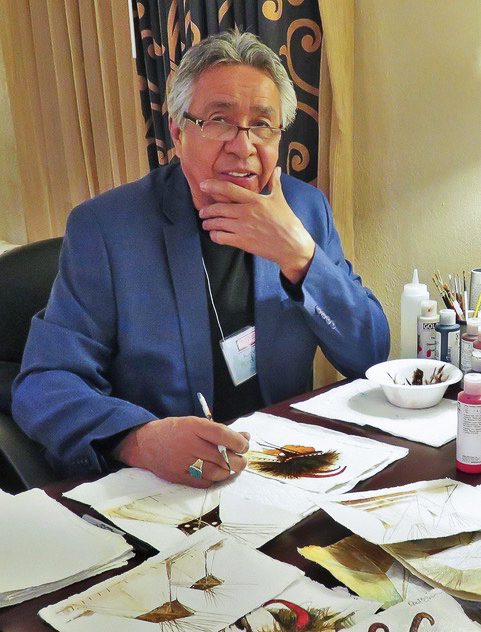 Artist working on feather art