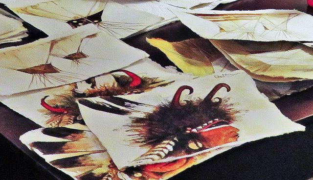 A small white dog in a stroller outside a clothing store.