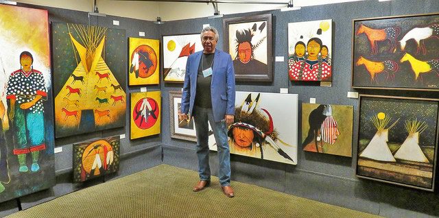 A small white dog in a stroller outside a clothing store.