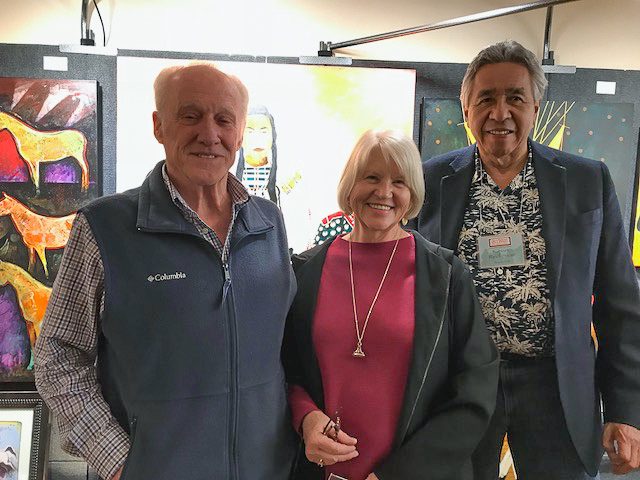 A small white dog in a stroller outside a clothing store.