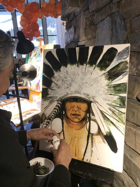 A small white dog in a stroller outside a clothing store.