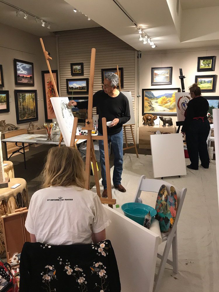 A small white dog in a stroller outside a clothing store.