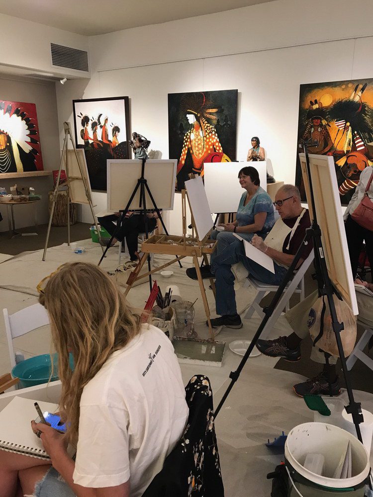 A small white dog in a stroller outside a clothing store.