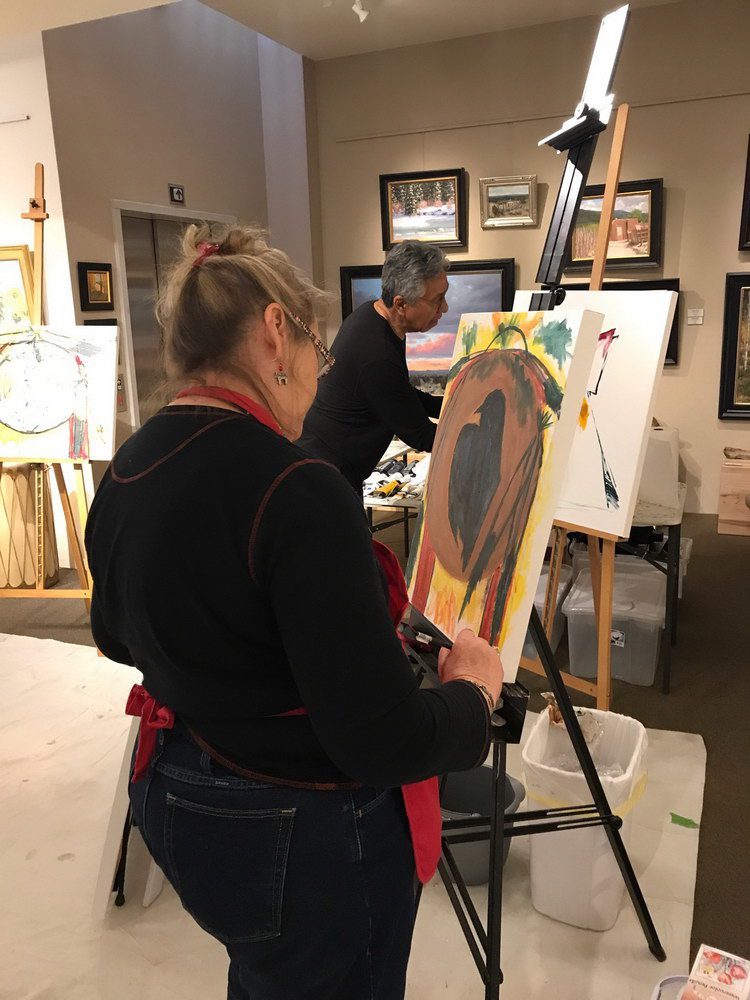 A small white dog in a stroller outside a clothing store.