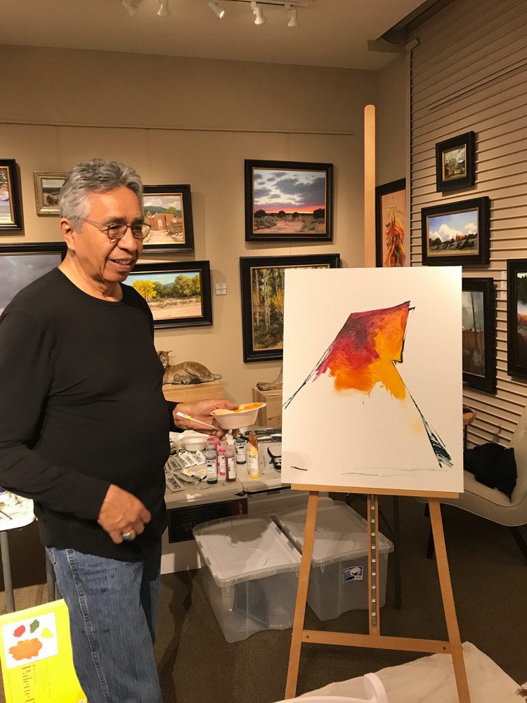 A small white dog in a stroller outside a clothing store.