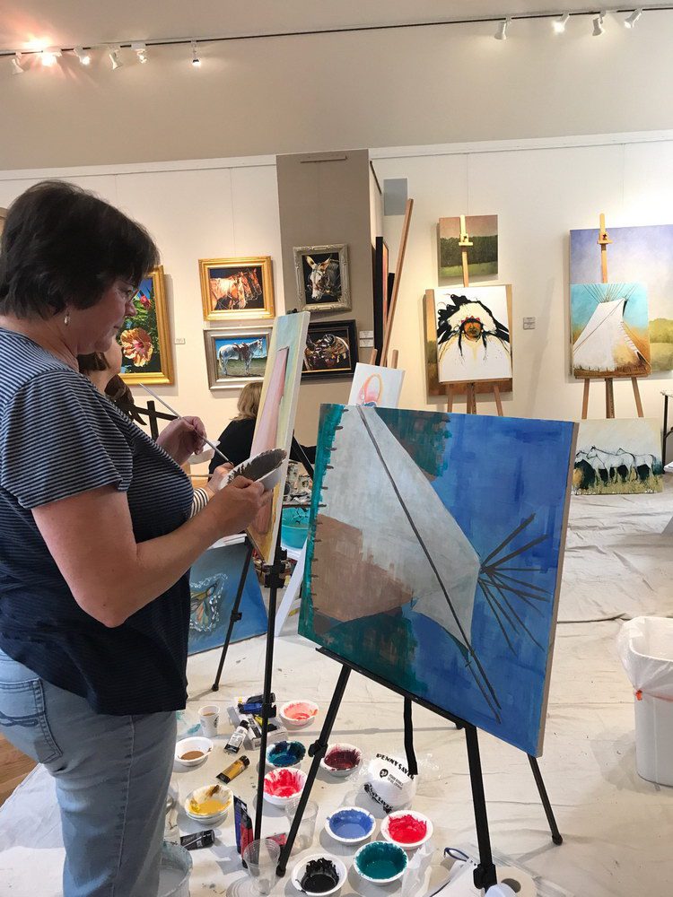 A small white dog in a stroller outside a clothing store.