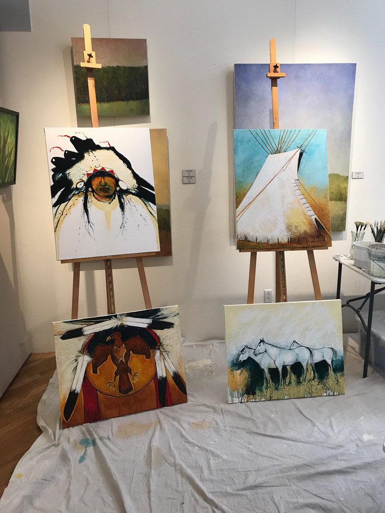 A small white dog in a stroller outside a clothing store.