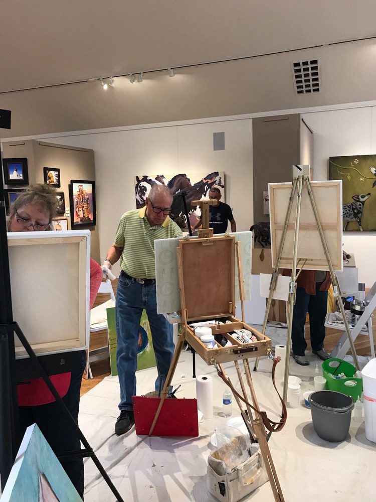 A small white dog in a stroller outside a clothing store.