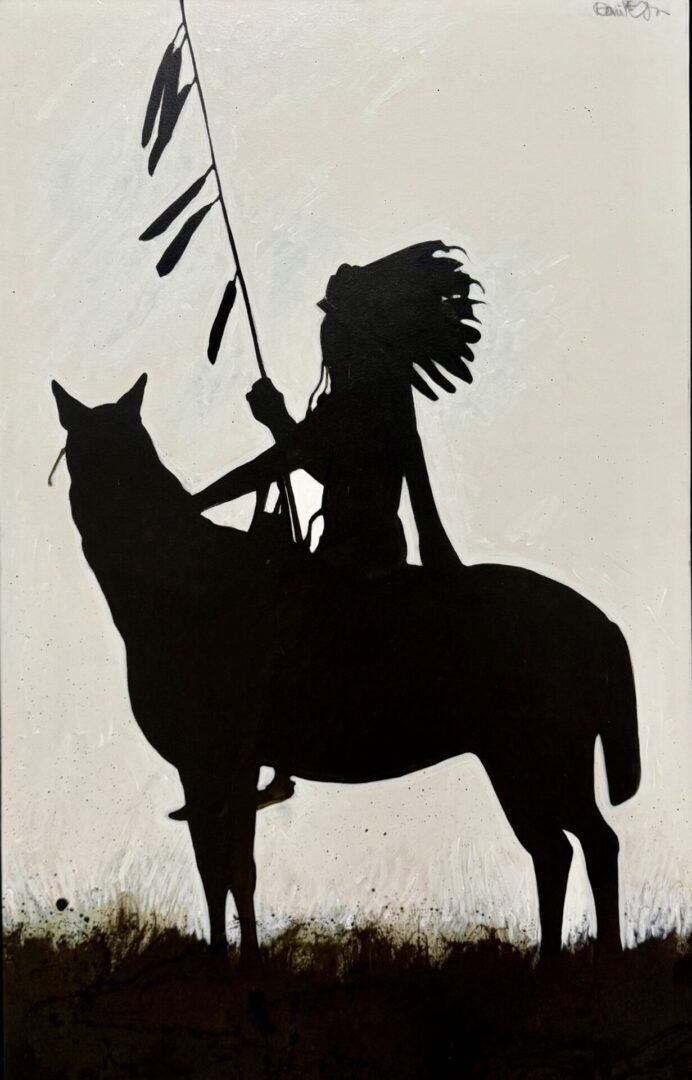 Silhouette of a Native American warrior on horseback holding a feathered staff.