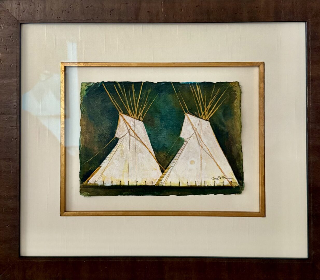 Framed artwork of two white teepees against a dark green background.