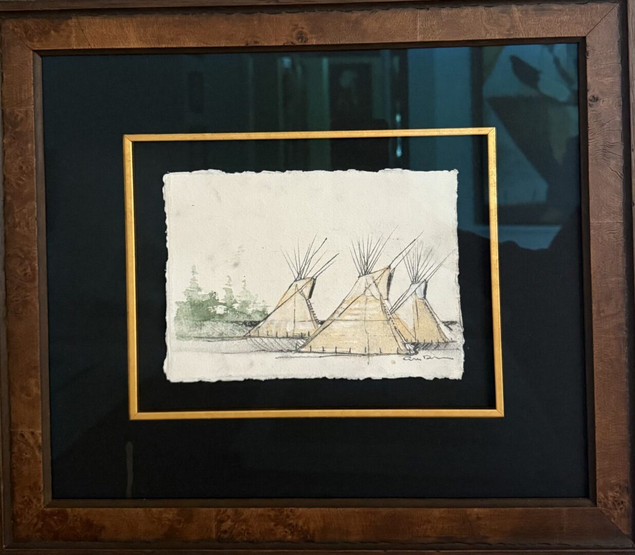 Framed artwork of three Native American teepees with forest background.