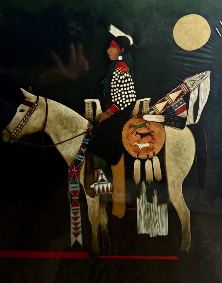 Native American warrior on a horse under a full moon.
