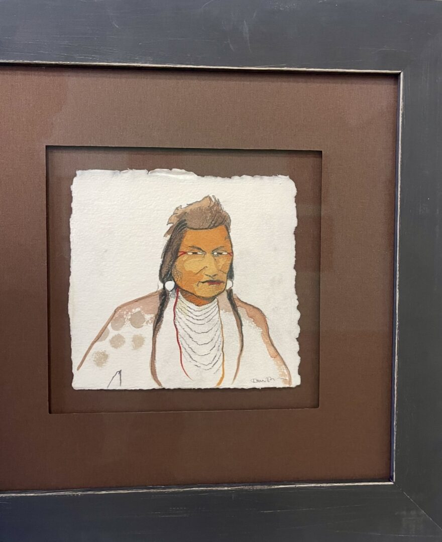 Framed painting of a Native American man with traditional attire and jewelry.