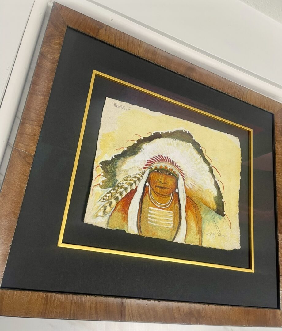 Framed artwork of a Native American chief in traditional headdress.