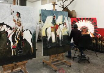 Artist painting Native American-themed artwork