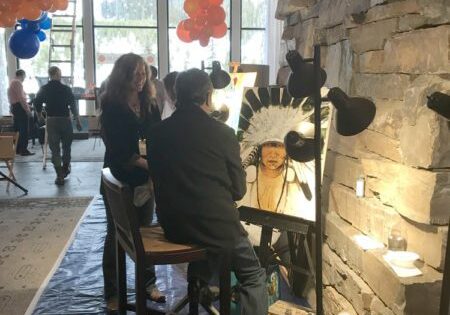 Painter working under balloon decorations